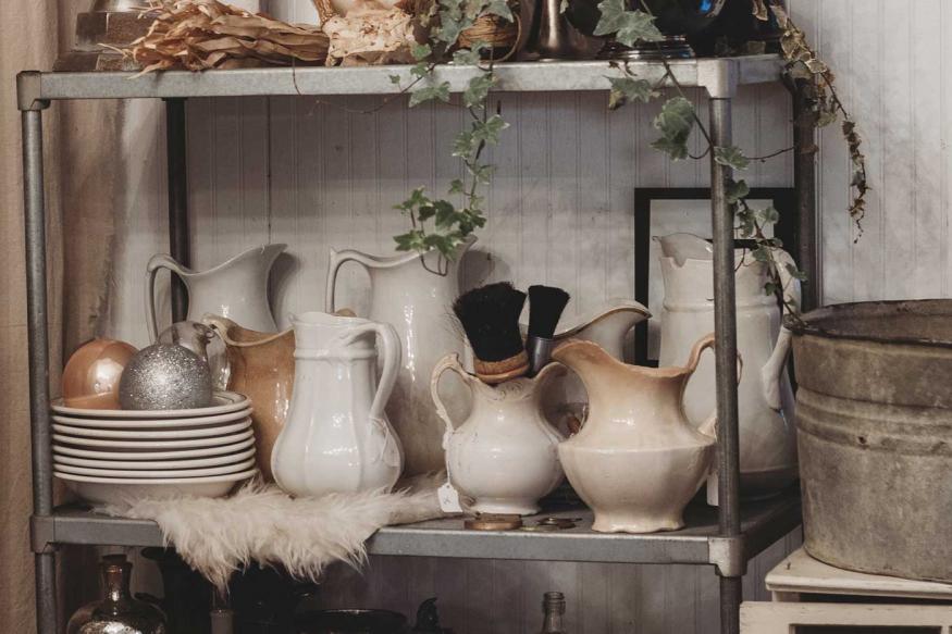 Store shelves with a variety of vases and decorative containers