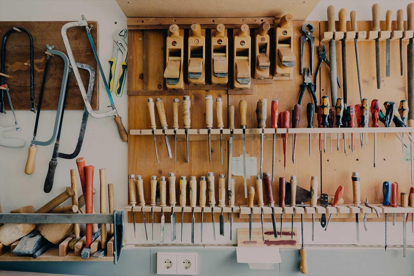 Workshop wall covered in hanging tools for woodworking