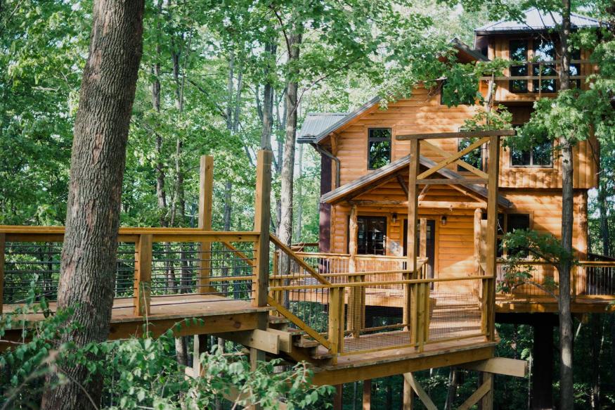 Two-story log cabin nestled in the woods