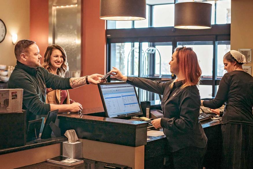 Couple checking into a hotel in Amish Country