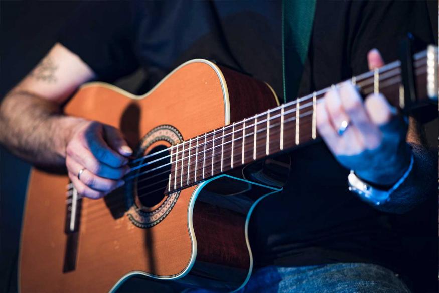 Man playing acoustic guitar on stage