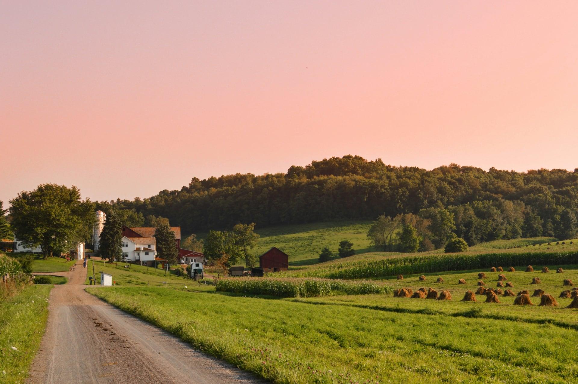 Sunset behind an active Amish farm