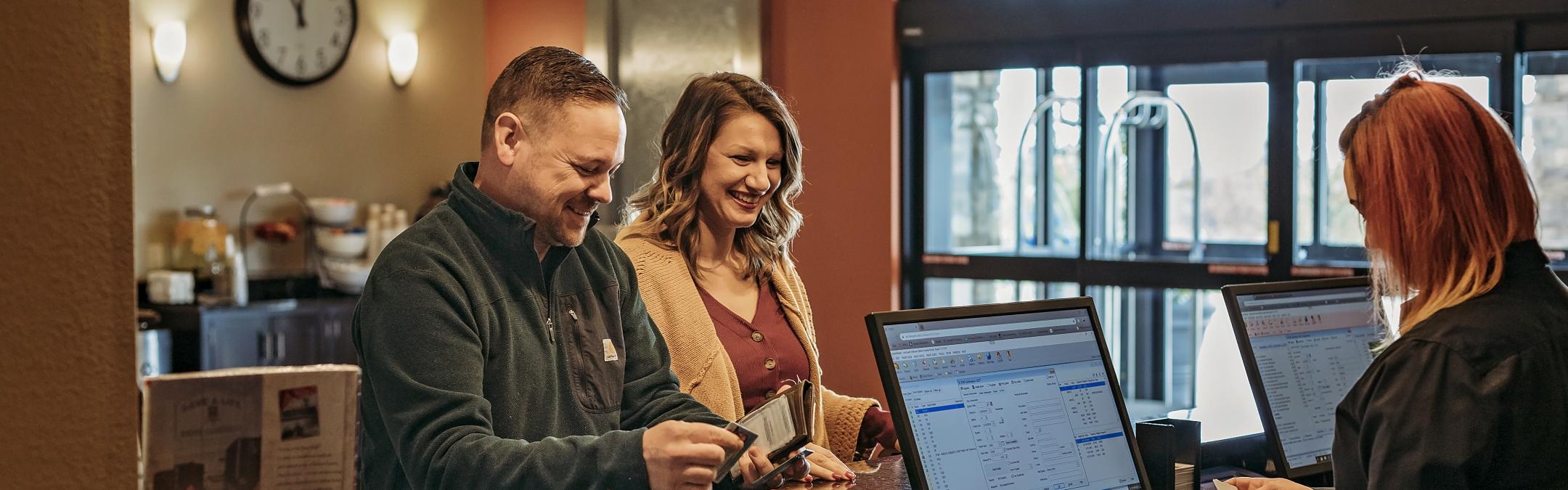 Couple checking into hotel
