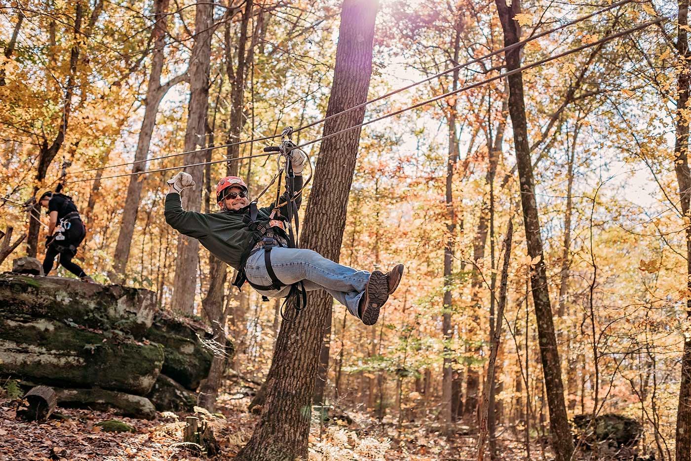 Man ziplining through trees